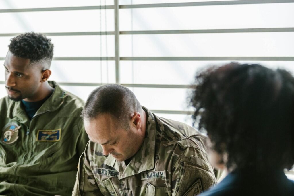 Service members talking in a group therapy session